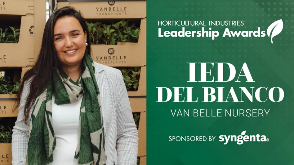A graphic with a green background and white letters reads Horticultural Industries Leadership Awards Ieda Del Bianco Van Belle Nursery Sponsored by Syngenta. To the left is a photo of a smiling woman with long brown hair wearing a gray and white striped blazer, a white shirt and a green and tan floral scarf. Behind her are cardboard boxes that say Van Belle Young Plants with green plants inside.